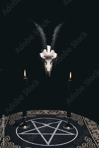 Fotografie, Obraz Witchcraft composition with goat skull, candles and pentagram symbol