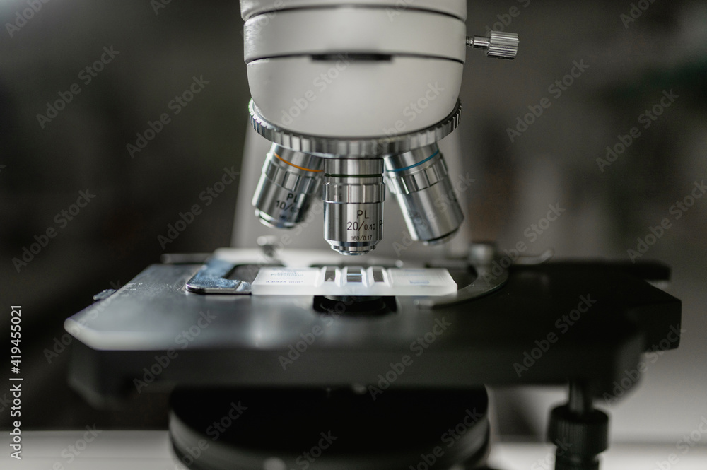 Closeup of contemporary professional microscope for professional scientific and medical research in modern lab Closeup of contemporary professional microscope for professional scientific and medical research in modern lab