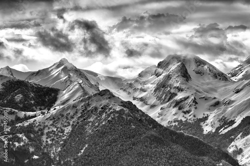 Black and white spectacular landscape of mountain range covered with snow in cold winter photo