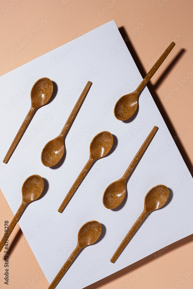 Overhead view of brown eco friendly spoons on pastel background Overhead view of brown eco friendly spoons on pastel background