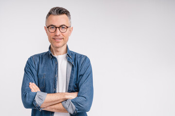 Successful caucasian middle-aged man in casual outfit with arms crossed isolated over white background