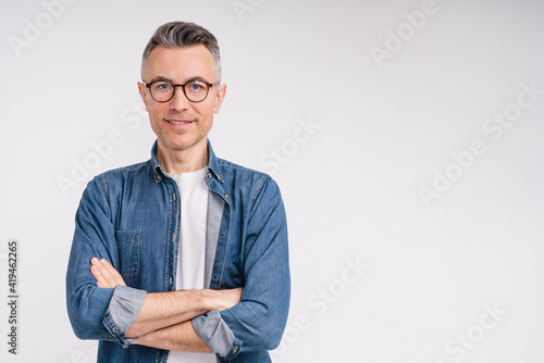 Successful caucasian middle-aged man in casual outfit with arms crossed isolated over white background photo