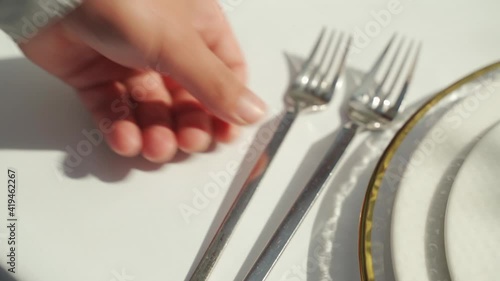 A hand serves a wedding table with fork