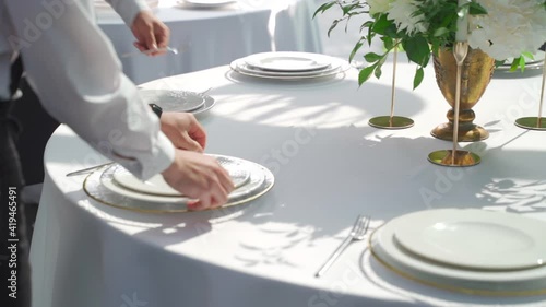 A man serves a wedding table