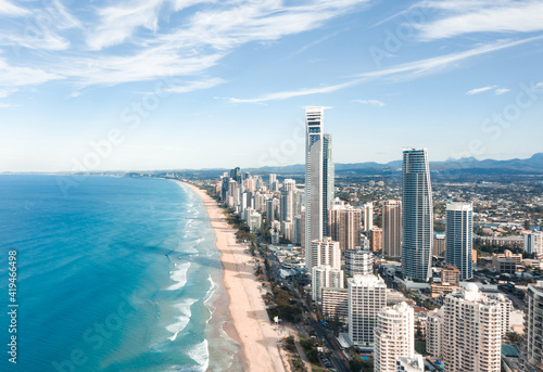 Breathtaking aerial view of modern skyscrapers located near famous sandy Surfers Paradise Beach washing by powerful ocean in Queensland photo