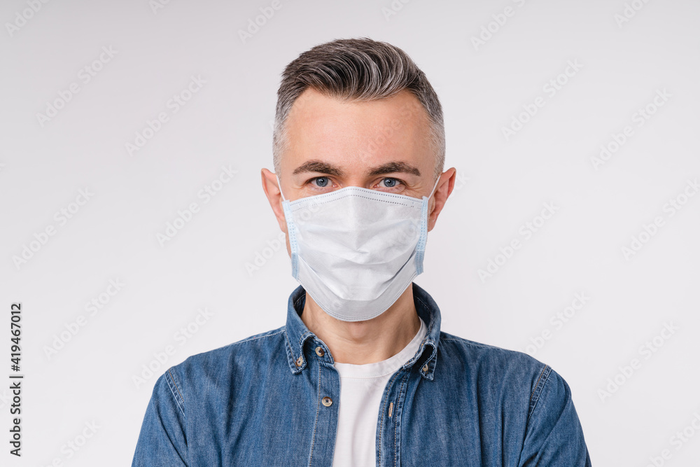 Mature caucasian man in protective medical mask isolated over white background Mature caucasian man in protective medical mask isolated over white background
