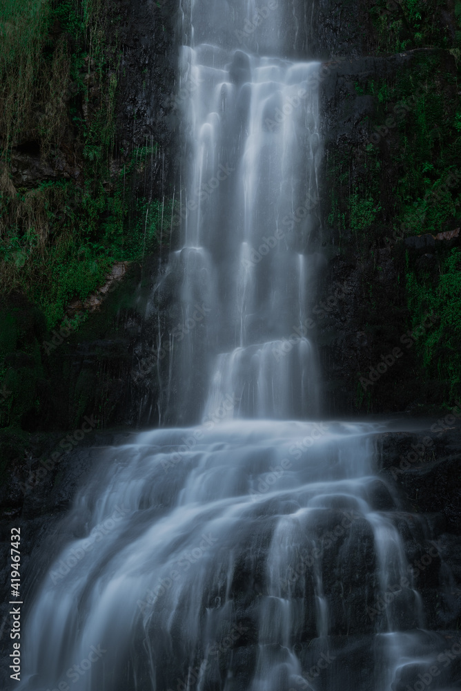 Picturesque view of small waterfall cascade streaming through forest in Cascada de Oneta in Asturias, Spain Picturesque view of small waterfall cascade streaming through forest in Cascada de Oneta in Asturias, Spain