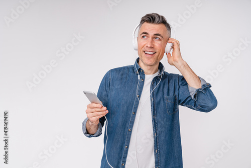 Amased caucasian attractive man listening to the music isolated over white background photo