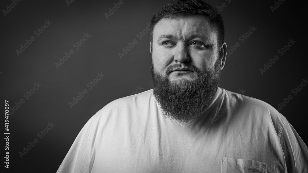 
portrait of a bearded cheerful, emotional and interesting man in a white T-shirt on a blue background showing various hand gestures. Cheerful guy is a show business artist, host of a glamorous show. 