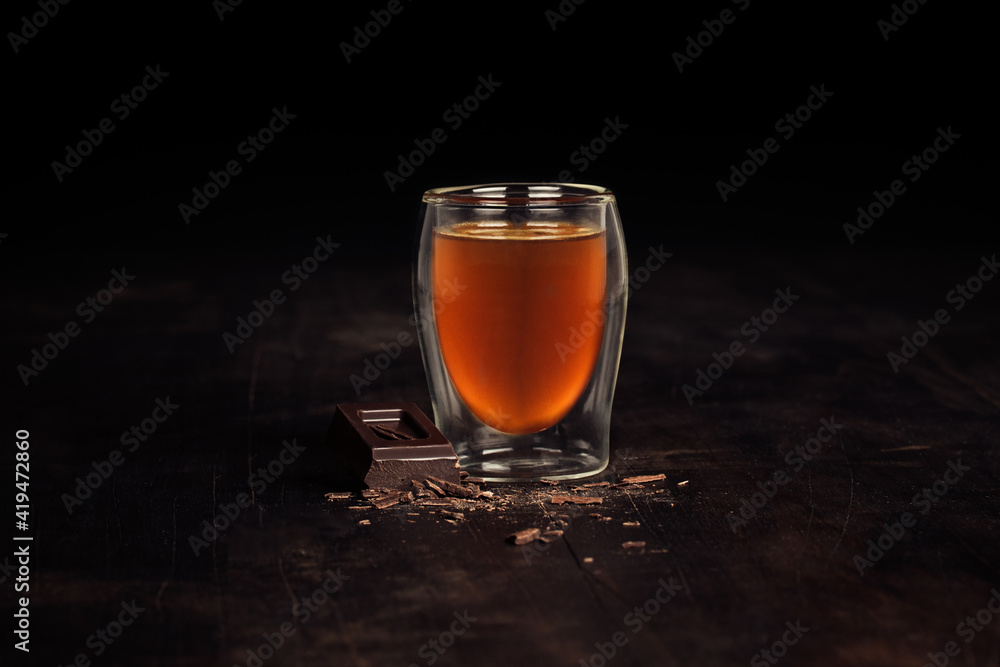 Closeup of a glass of tea with a chocolate Closeup of a glass of tea with a chocolate