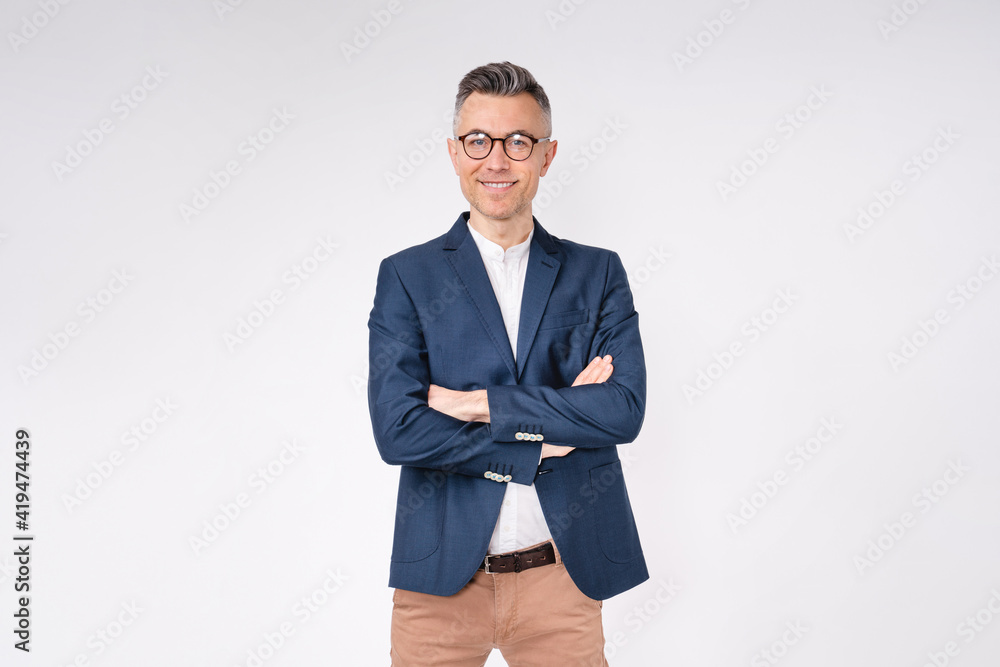 Confident handsome mature businessman standing with arms crossed isolated in white background Confident handsome mature businessman standing with arms crossed isolated in white background