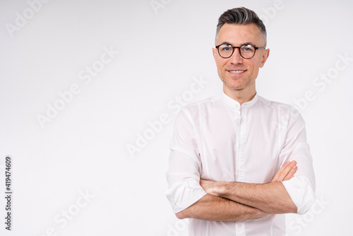 Confident middle-aged caucasian businessman in white shirt and glasses isolated over white background © InsideCreativeHouse