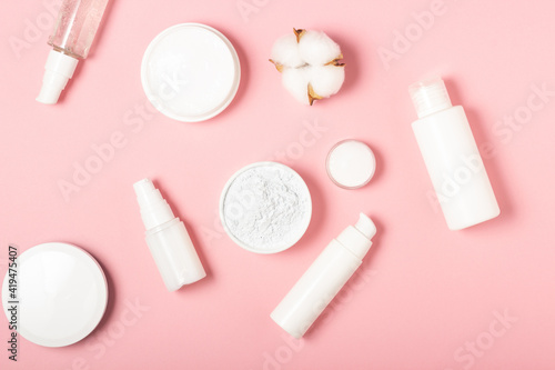 Alginate and clay face masks. Cosmetic products, masks and creams in jars. Top view, flat lay