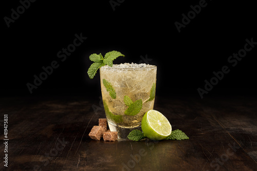 Closeup of a mojito with lots of ice on a table photo