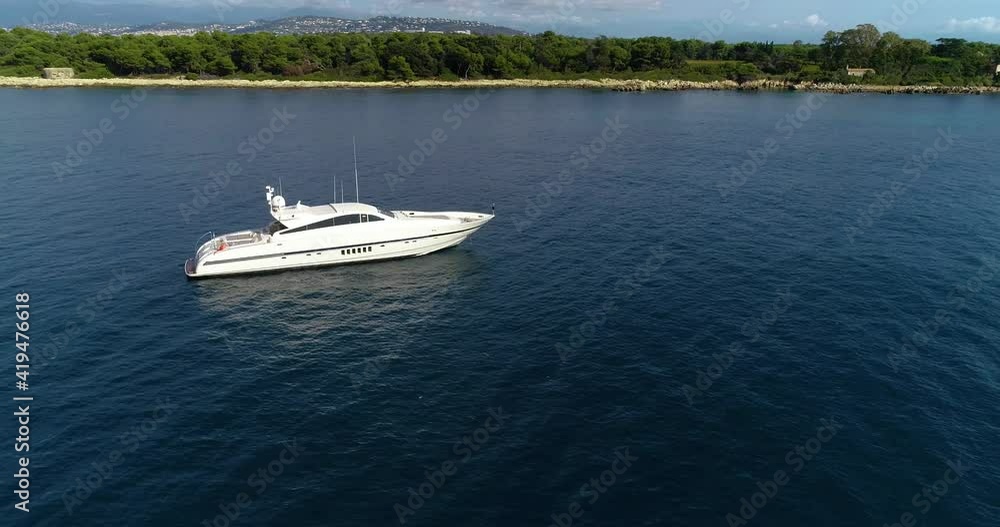 Aerial view of a motorboat in Monaco's coast in France. Aerial view with a drone high angle view Aerial view of a motorboat in Monaco's coast in France. Aerial view with a drone high angle view