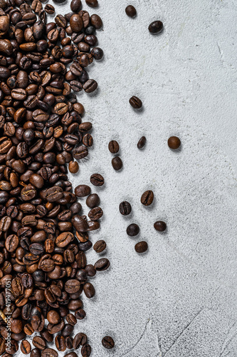 Roasted coffee beans on rustic table. White background. Top view. Copy space