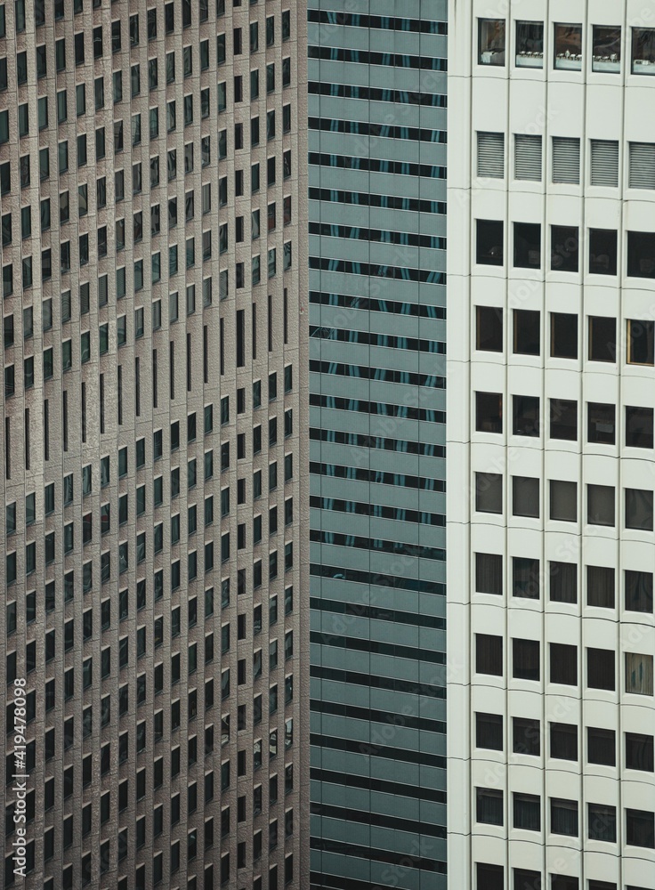 View to high skyscrapers towers and small buildings in big city View to high skyscrapers towers and small buildings in big city