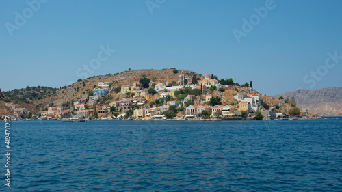 Beautiful view from the water of colorful Symi island in summer. Dodecanese, Greece © Majopez