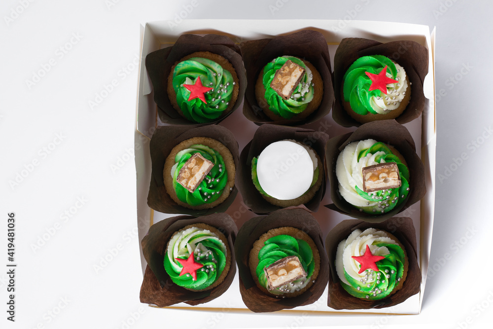 cupcakes with cream and red stars on a white background cupcakes with cream and red stars on a white background