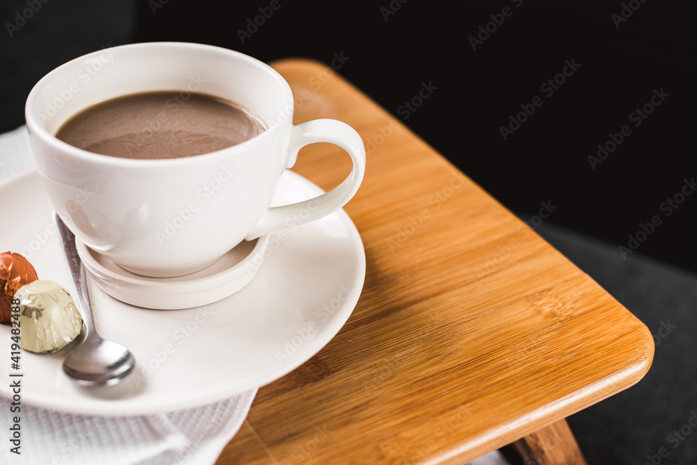 Close-up morning cup of coffee with milk and with candy on the table Close-up morning cup of coffee with milk and with candy on the table