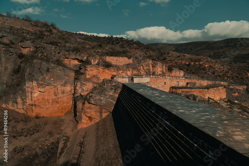 presa sin agua al lado de la montaña photo