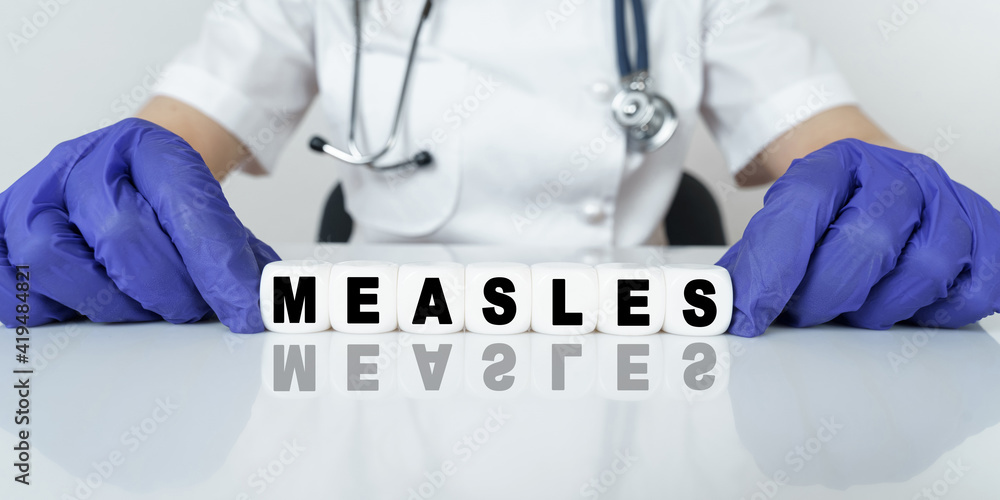 The doctor put together a word from cubes MEASLES The doctor put together a word from cubes MEASLES