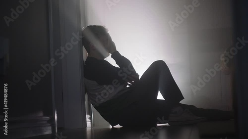 young man crying on floor