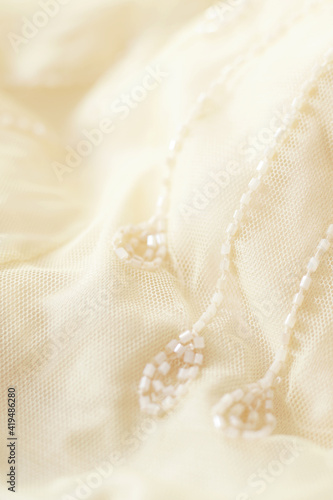 elegant light pastel fabric with embroidery beads, aesthetic background