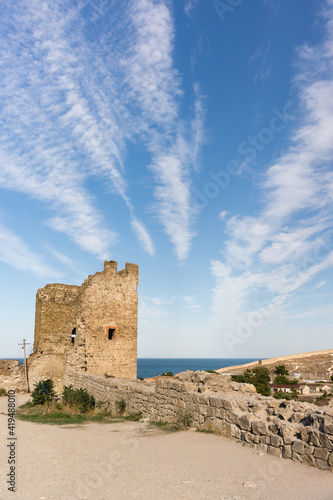 View from inside the medieval fortress of Kafa on the shore of the Gulf Feodosia on the defensive tower of Krisko against the beautiful sky