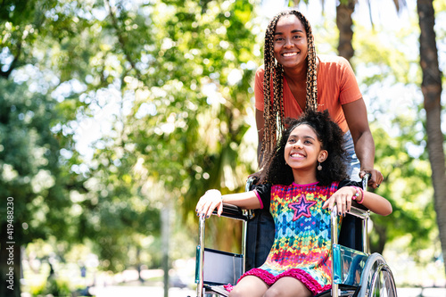 Wallpaper Mural Little girl in a wheelchair at the park with her mother. Torontodigital.ca