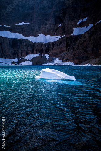 lone iceberg floating in Iceberg lake in Glacier National Park in Montana. photo