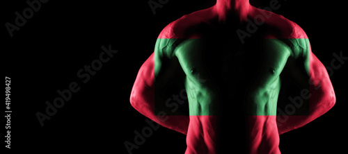 Maldives flag on muscled male torso with abs photo