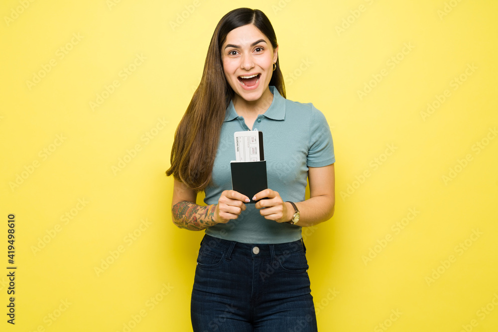 Woman shouting with excitement and holding a plane ticket Woman shouting with excitement and holding a plane ticket