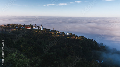 View of the church on the hill above the clouds