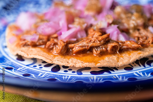 closeup of tostada, typical dish of Mexico, of cochinita pibil