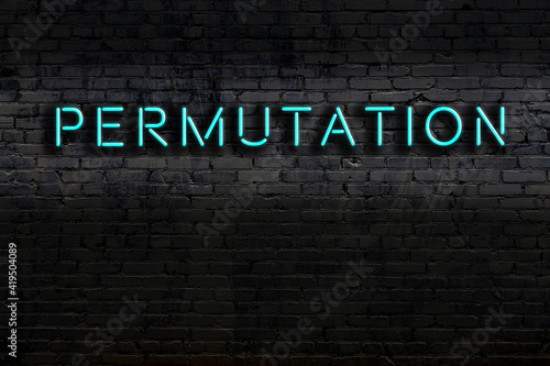 Night view of neon sign on brick wall with inscription permutation
