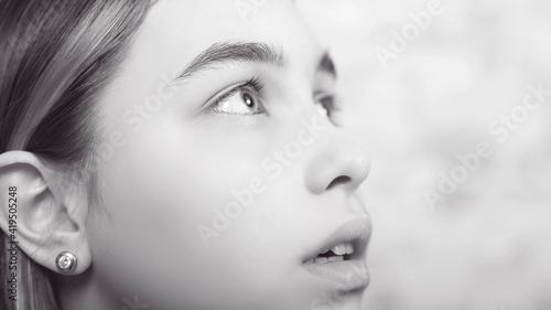 black and white portrait of a teenage girl, looking up