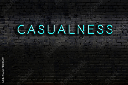 Fotografía Neon sign. Word casualness against brick wall. Night view
