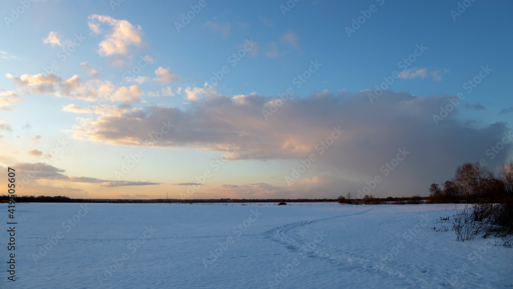 Sunset in the winter field. Snow road. Winter field panorama. Sunset in the winter field. Snow road. Winter field panorama.