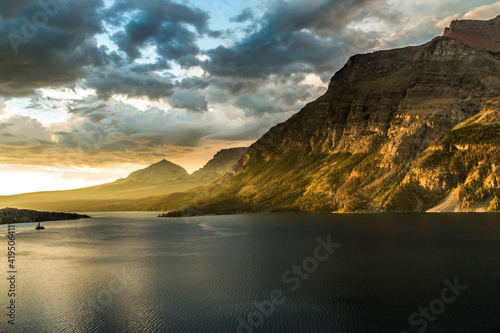 dramatic golden summer sunrise in St Mary's lake in Glacier national park in Montana. © Nathaniel Gonzales
