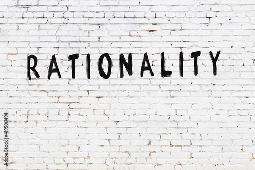 Inscription rationality painted on white brick wall