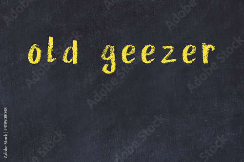 Black chalkboard with inscription old geezer on in