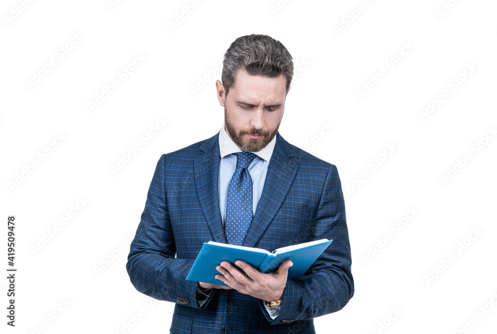 handsome businessman man in suit reading notes in notebook isolated on white, examining. handsome businessman man in suit reading notes in notebook isolated on white, examining.