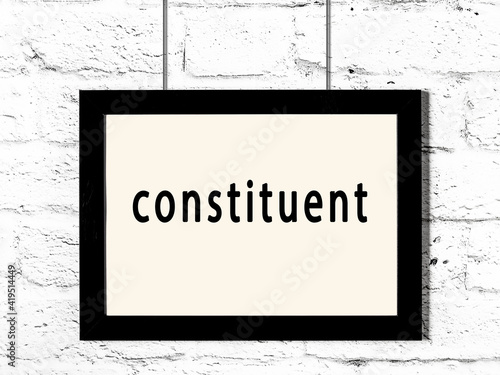 Принти на полотні Black frame hanging on white brick wall with inscription constituent