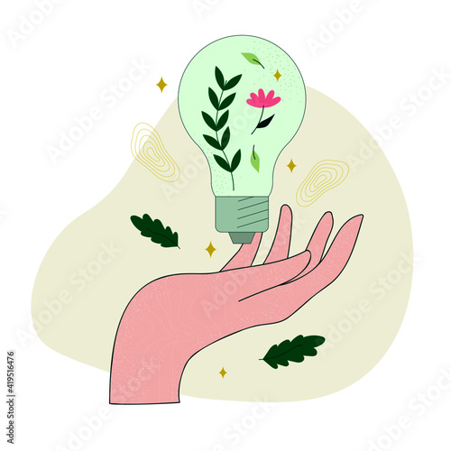 Main ouverte et ampoule écologie