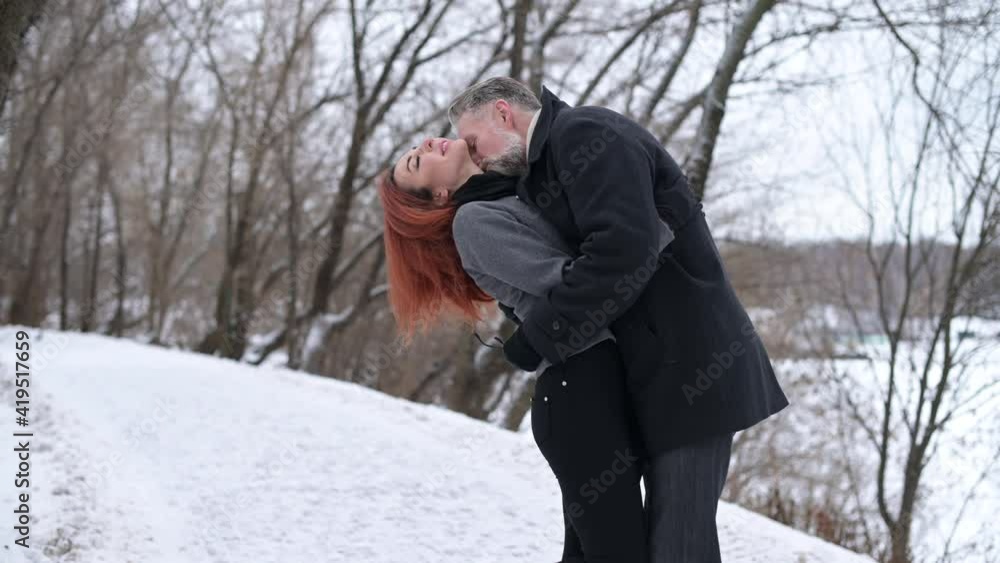 A man and a woman kissing in the park, the camera zoom in A man and a woman kissing in the park, the camera zoom in