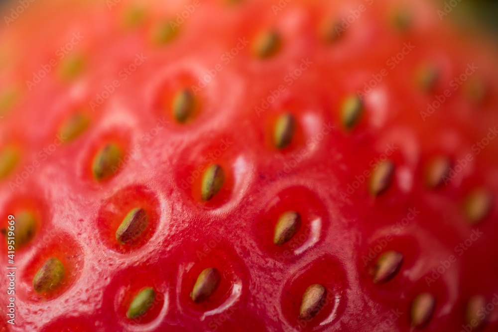 Macro of a red fresh strawberry with yellow seeds Macro of a red fresh strawberry with yellow seeds