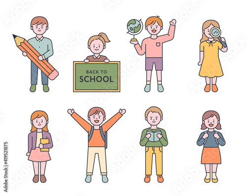 A collection of small and young elementary school characters. Children are standing with various objects in their hands. flat design style minimal vector illustration.