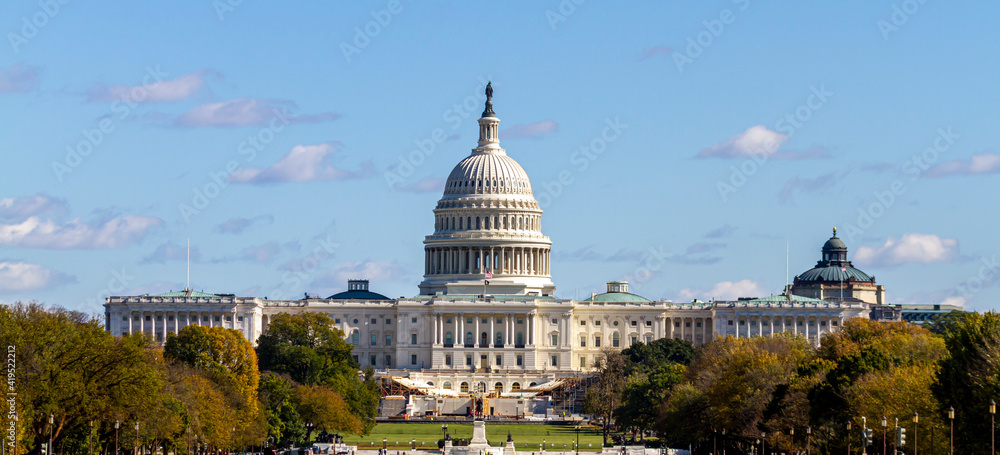 Fototapeta premium Panoramic image of the US Capitol building in Washington DC as seen from national mall This iconic place holds senate and congress. It is a sunny autumn day and clear sky with a few clouds