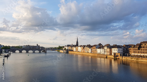 View to Maastricht from the pedestrian bridge over Meuse River at the sunset. Netherlands.